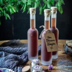 chive blossom vinegar in bottles on a table