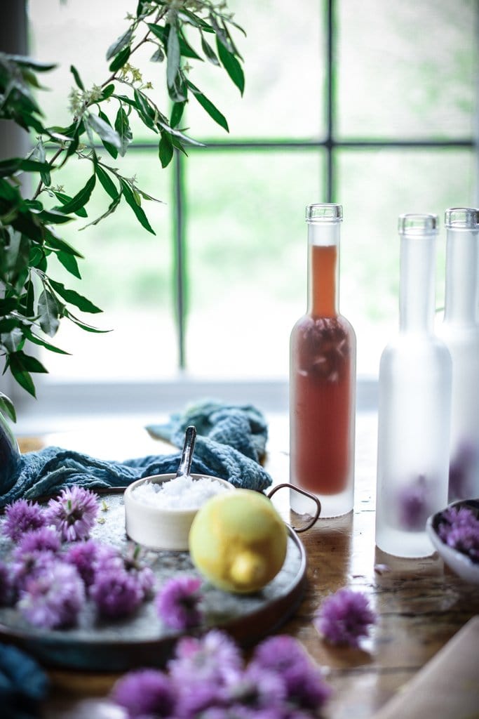 chive blossom vinegar in bottles on a table