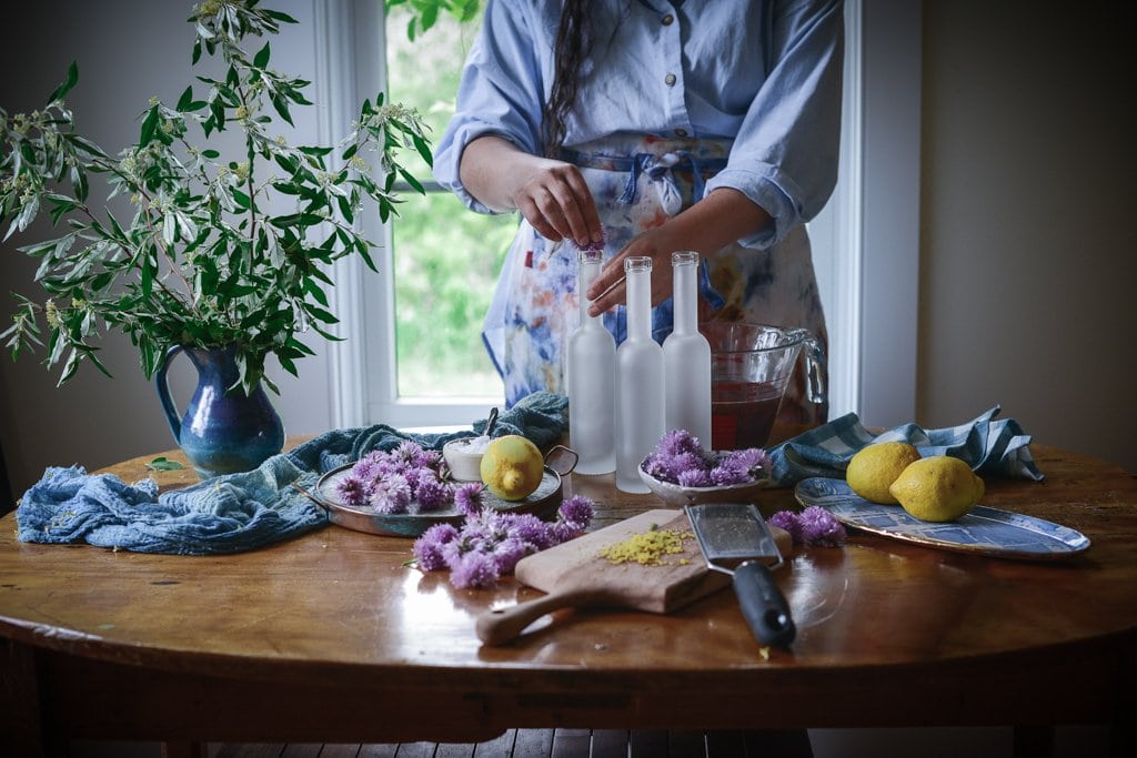 Kaity adds chive flowers to empty bottles