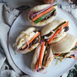 close up top down view of vegan Bao Buns with Hoisin Mushrooms and Pickled Vegetables on a table