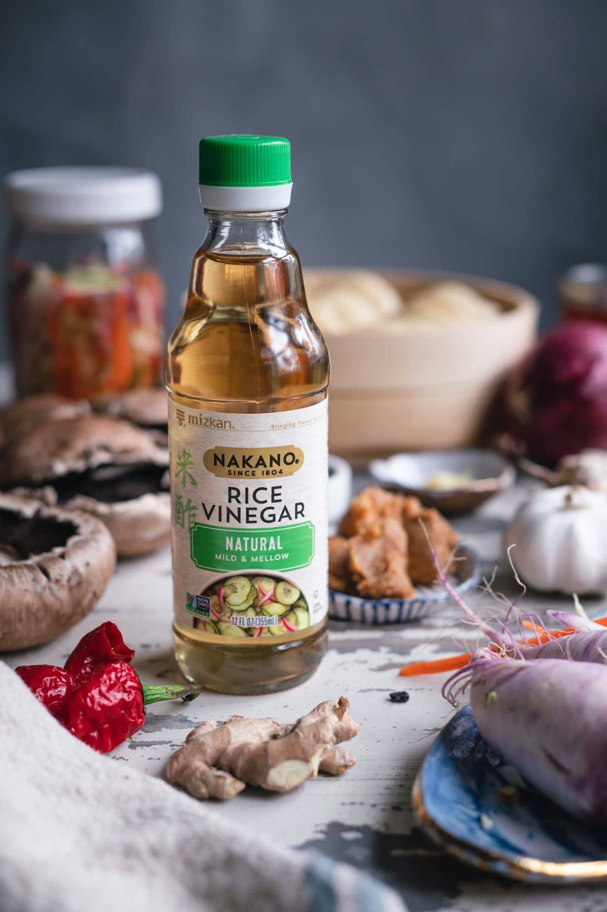 closeup of rice vinegar bottle on a tbale with other ingredients