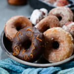 a variety of vegan sourdough donuts on a table.