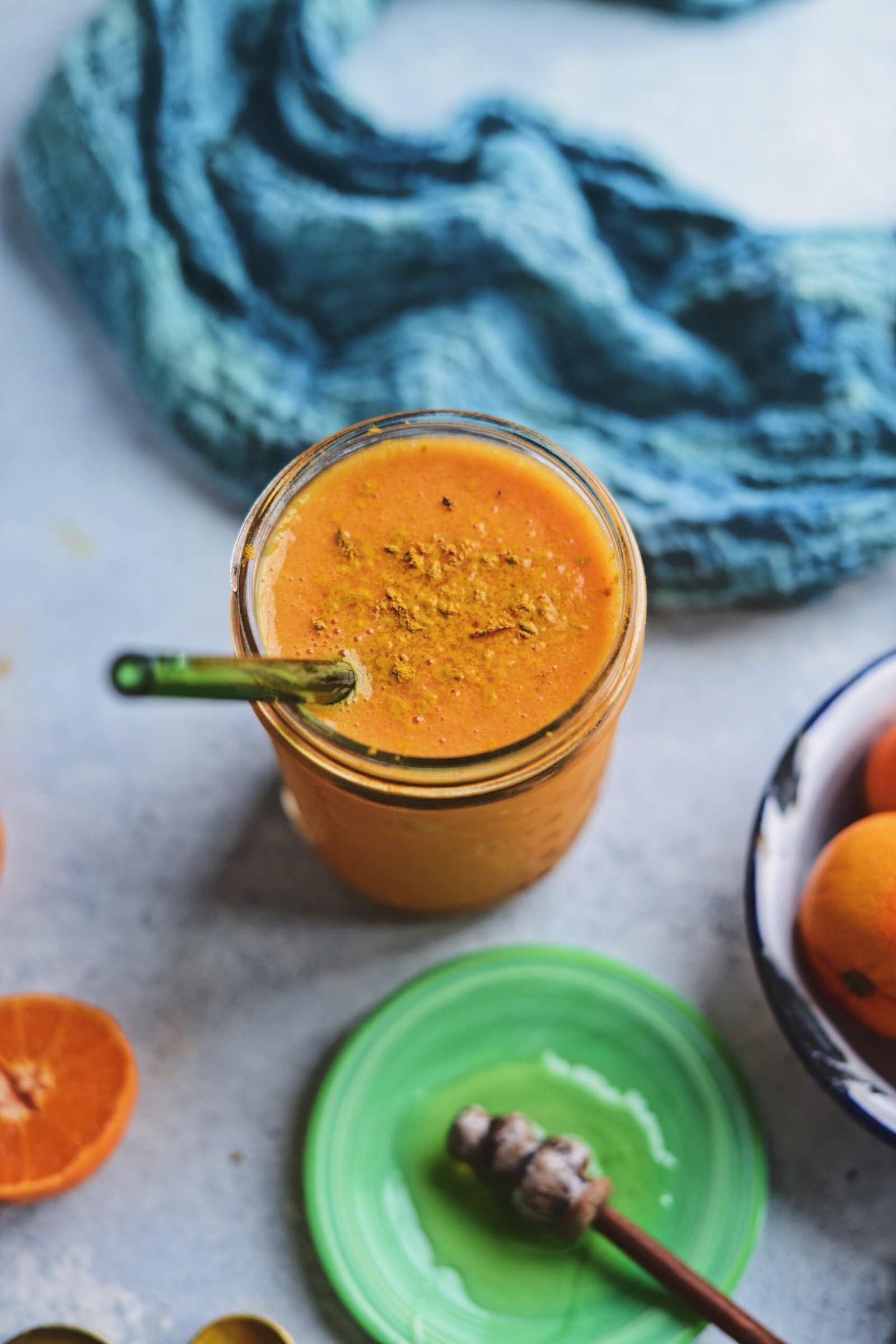Vitamin C immunity smoothie in a mason jar with a green glass straw