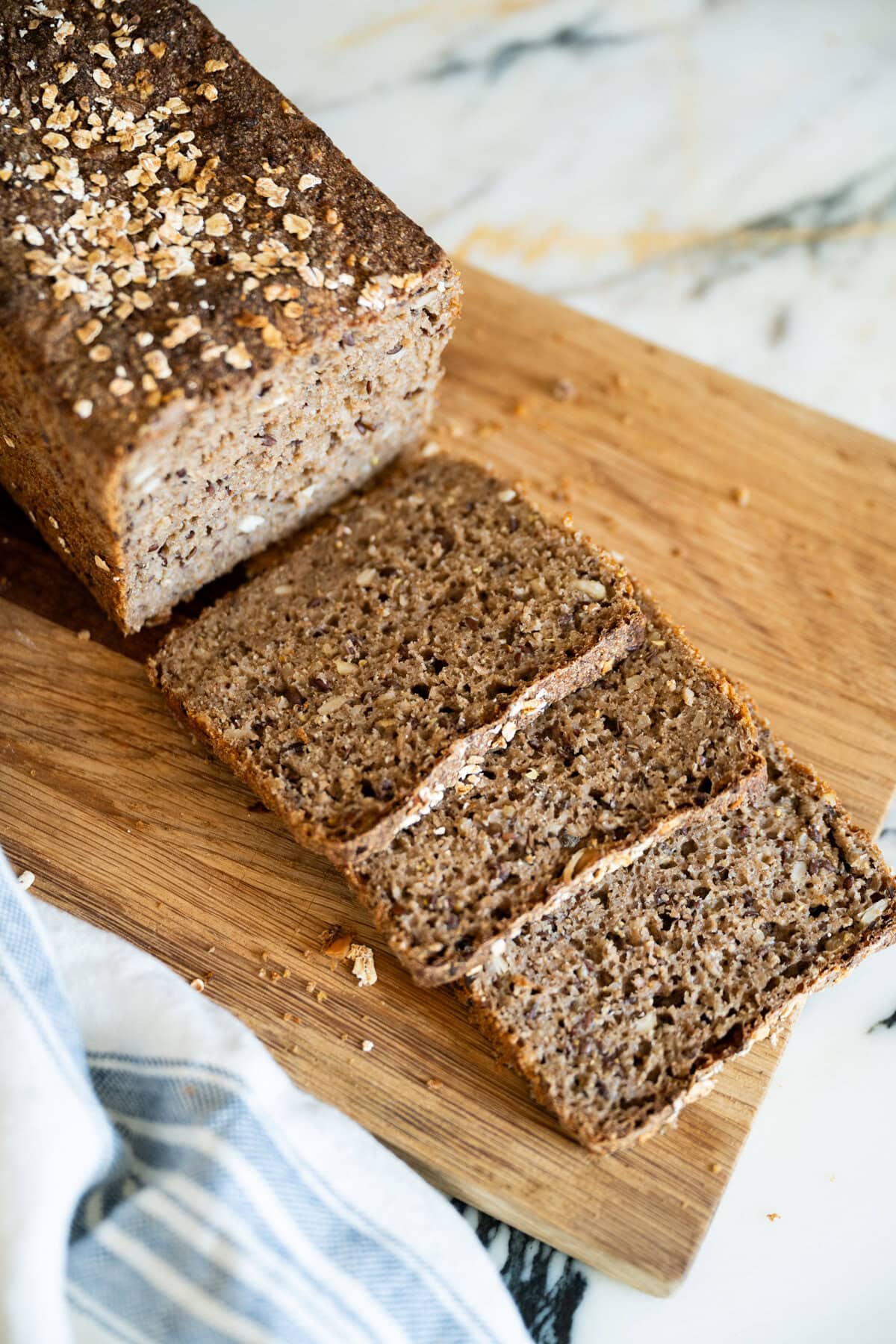 Easy sourdough Danish rye bread recipe (rugbrød) with seeds, sliced and ready to serve.