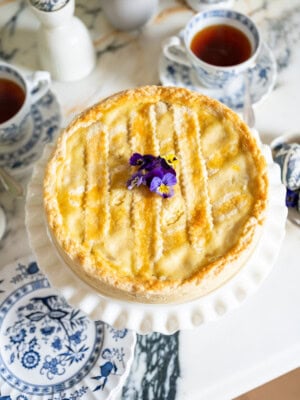 Pastiera Napoletana served on an Easter dessert table with spring decorations