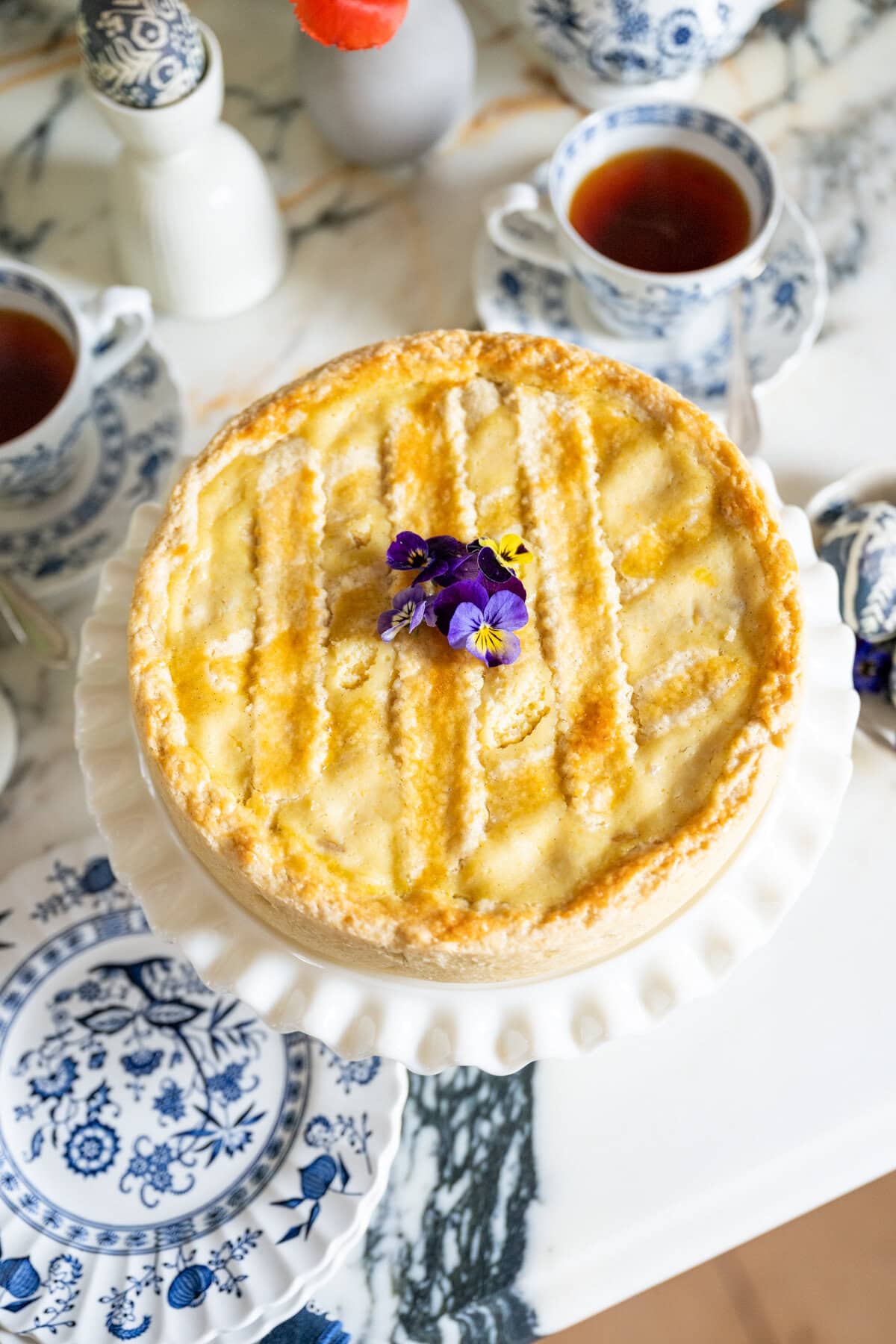 Pastiera Napoletana served on an Easter dessert table with spring decorations