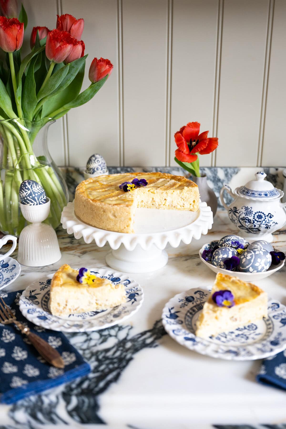 Pastiera Napoletana served on an Easter dessert table with spring decorations